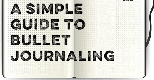 An open dotted Bullet Journal with the title