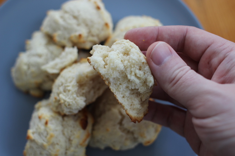 A person holding an easy biscuit on a plate.