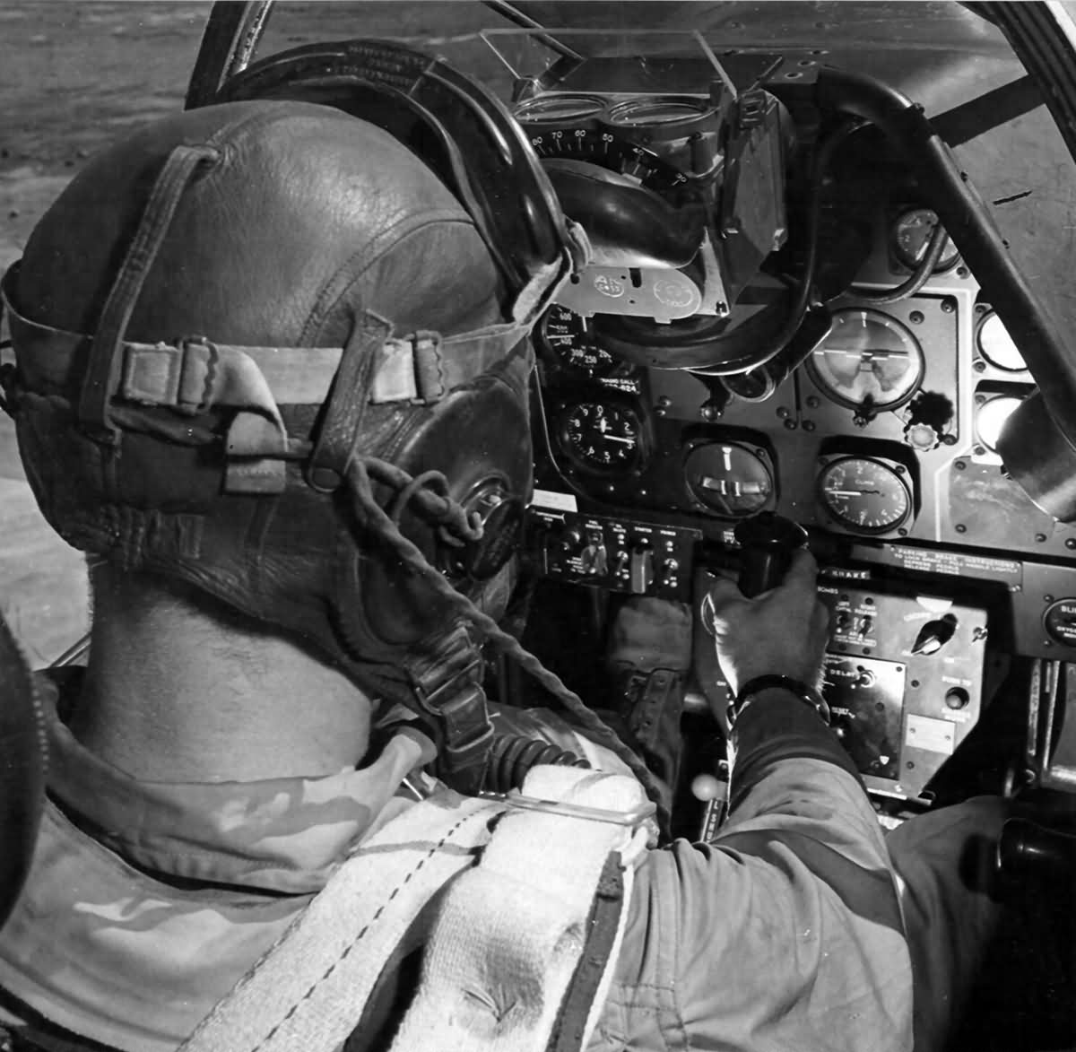 A man with courage sits in the cockpit of a plane.