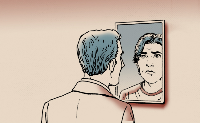 A 16-Year-Old boy gazes at himself in the mirror, reflecting on his appearance.