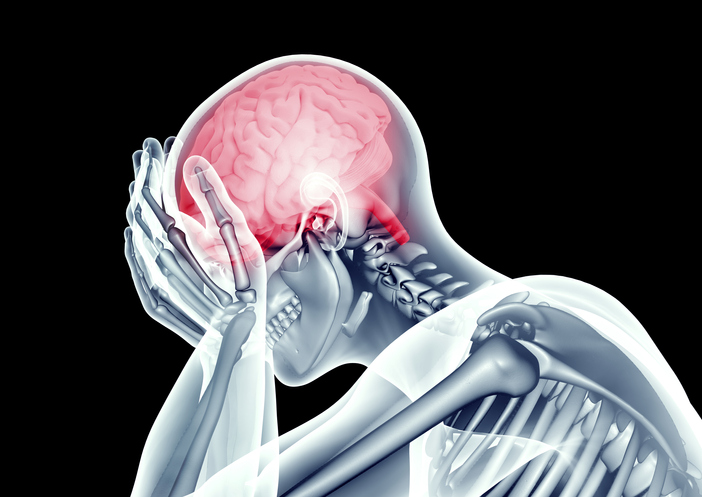 An image of a person holding their head in pain due to inflammation.