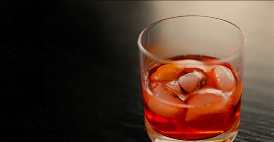 A cocktail glass with ice in it.