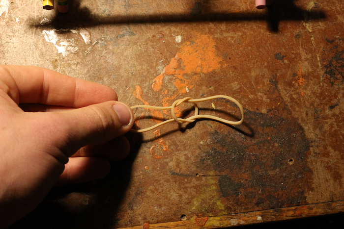 Two rubber bands sharing a knot with each other.