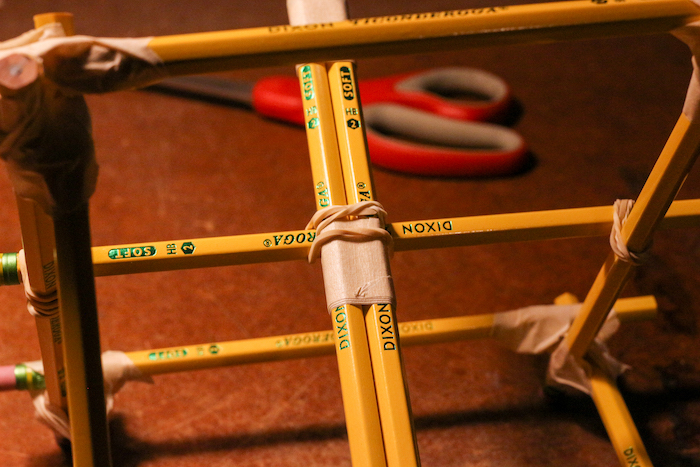Pencils are fixed by the help of tap and rubber bands. 