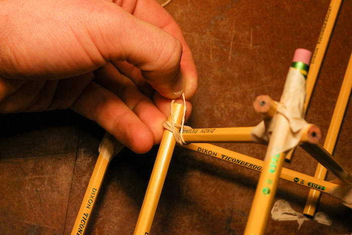 Rearranging Rubber bands with hand.