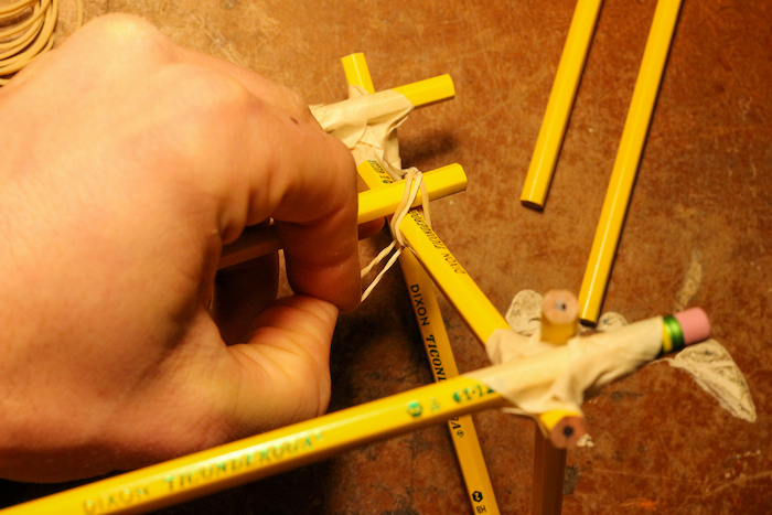 Fixing pencils through Rubber Bands. 