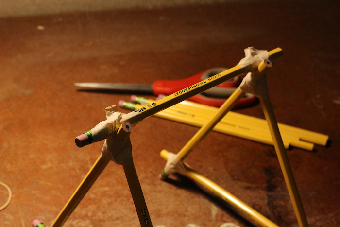 Connecting the two triangular shaped pencils with a single pencil from top.