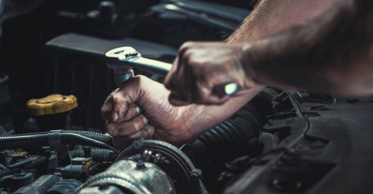 With some helpful tips, the man is DIY fixing the car engine.