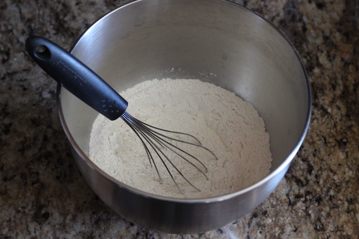 Mixture of yeast, flour, and salt placed in a bowl. 