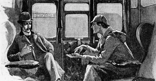 Two men sitting in a train chatting with each other about a podcast they enjoy.