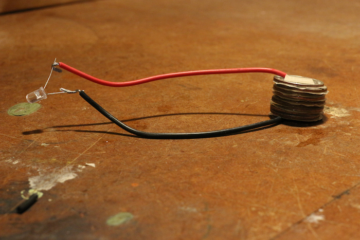 A red wire is sitting on a table.