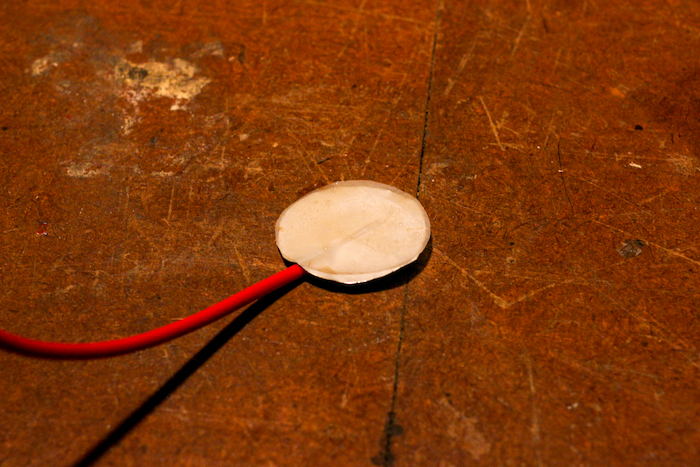 Combination of foil and paper attached to wire placed on ground. 