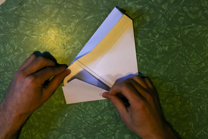 Squaring the corners of the paper by hands.