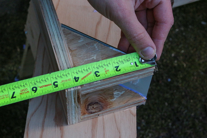 Measuring plywood with scale.