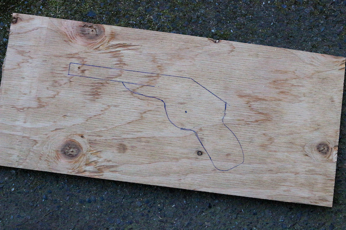 Wood with gun drawn on it. 