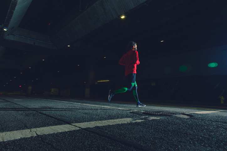 A man is running on a road. 