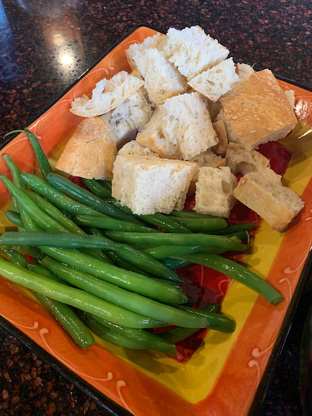 Fresh beans and bread crumbs in a dish.