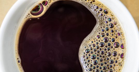 This close up image showcases a cup of coffee, perfect for those who need a caffeine boost.