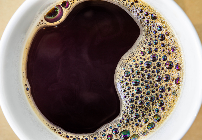 This close up image showcases a cup of coffee, perfect for those who need a caffeine boost.