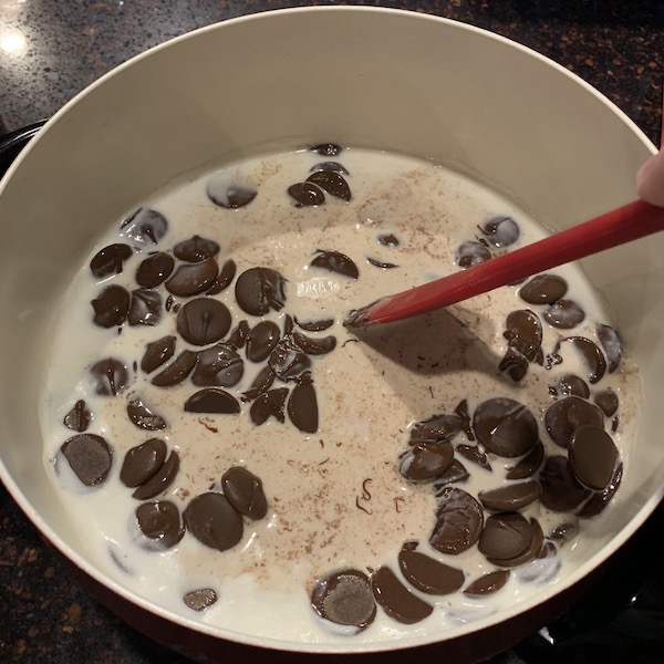 Mixing of Chocolate chips in milk. 