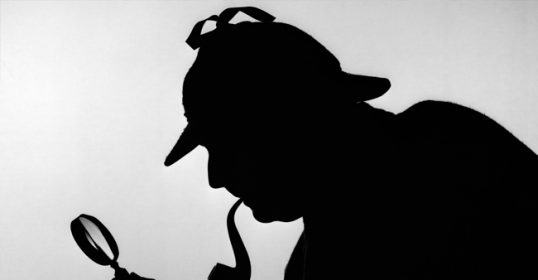 A silhouette of a man holding a magnifying glass, reminiscent of Sherlock Holmes.