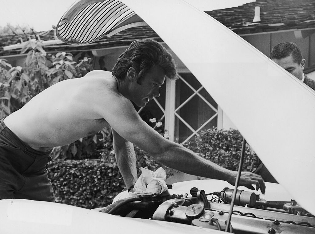 A man repairing the engine of the vehicle. 