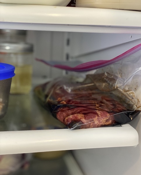 Marinating sauce with other food items stored in refrigerator.
