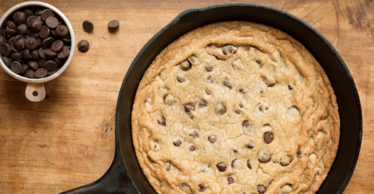 A classic chocolate chip cookie baked in a cast iron skillet.