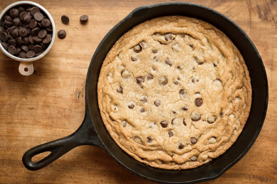 A classic chocolate chip cookie baked in a cast iron skillet.