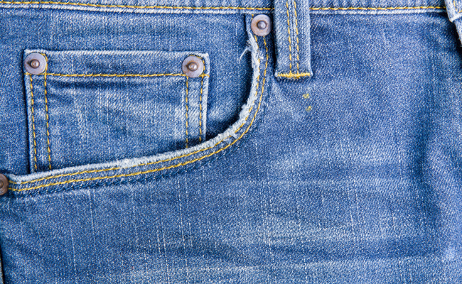 The jeans pocket is stitched onto the pants.