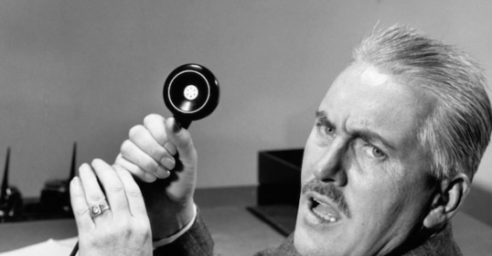 A man in a suit is holding a telephone to deal with jerks.