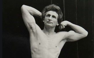 A black and white photo of a man posing, showcasing his fitness influencer persona.