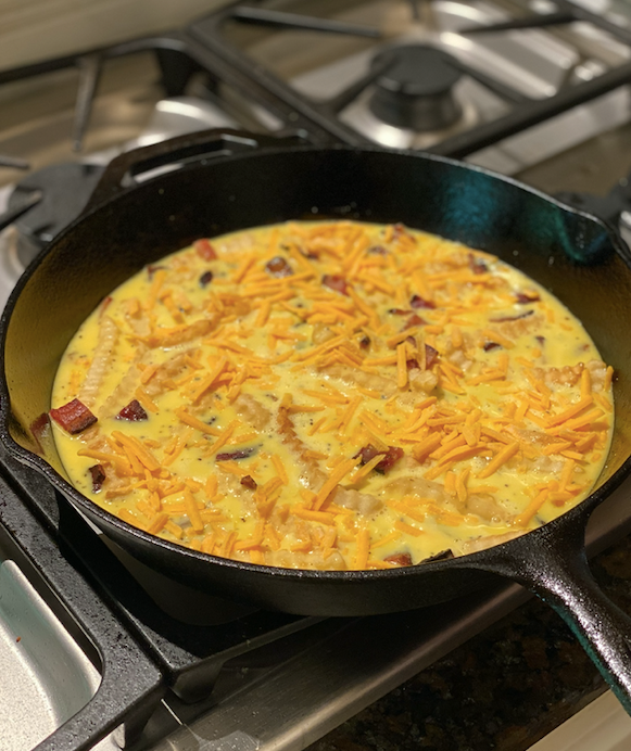 Making of Frittata with leftover fries in fryingpan.