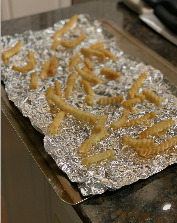 Curly fries on an aluminum foil.