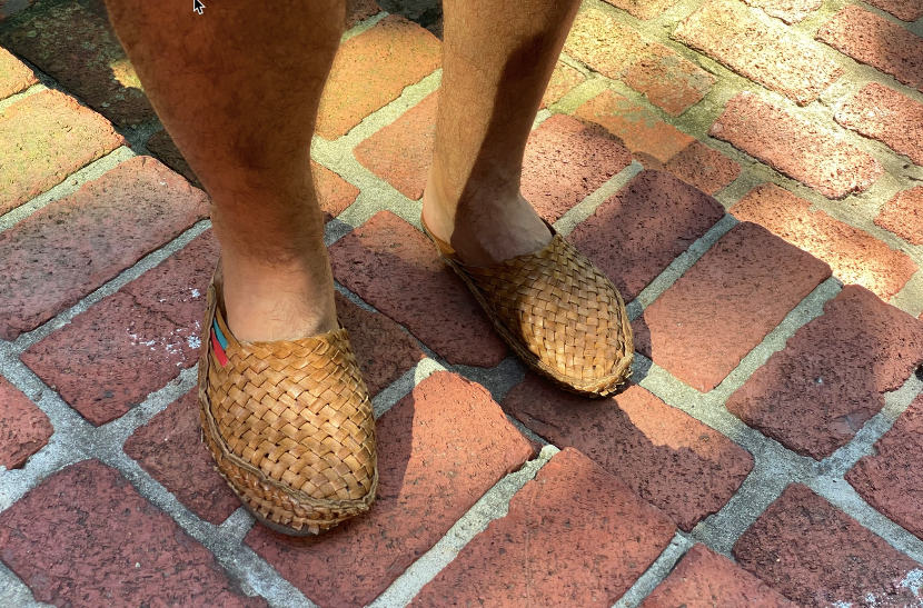 A man wearing summer shoes.