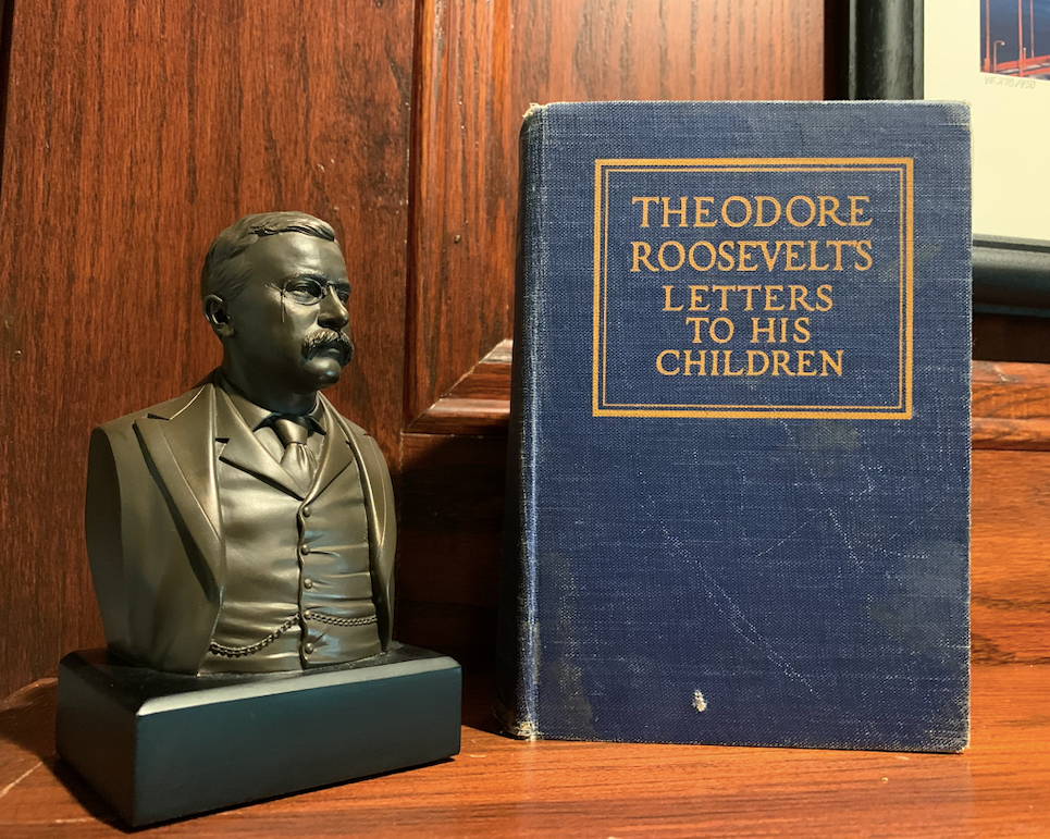 Theodore Roosevelt statue with his book.