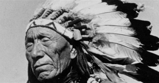 An old black and white photo of an Indian chief, Black Elk.