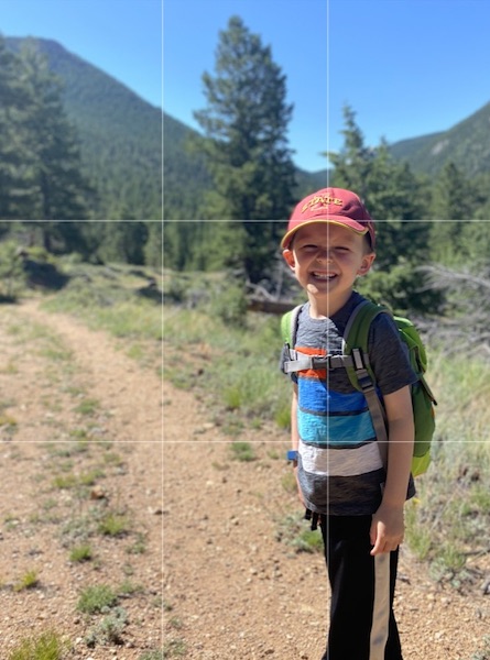 young boy on a trail with photo grid lines overlaid. 