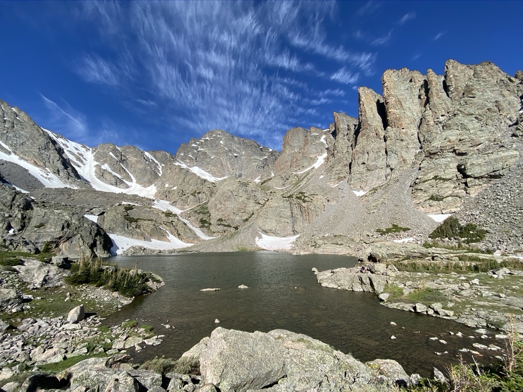 A lake with mountains and blue sky.