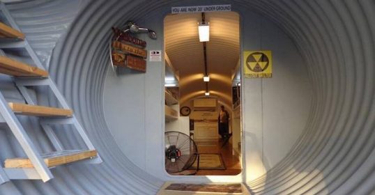 A bunker with stairs leading into a house.