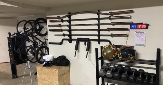 A garage with a bike rack for organizing equipment.