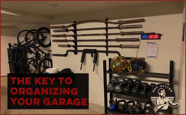 garage gym organized with dumbells and barbells on racks.