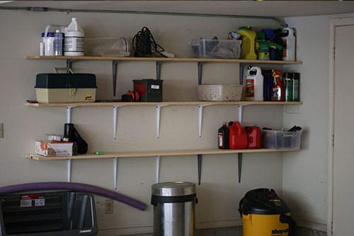 shelves mounted on the wall of a garage for storage. 