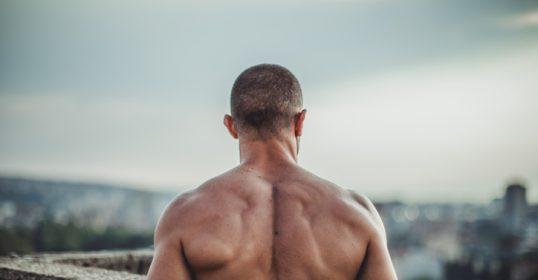A man achieving physical autonomy gazes at the city.