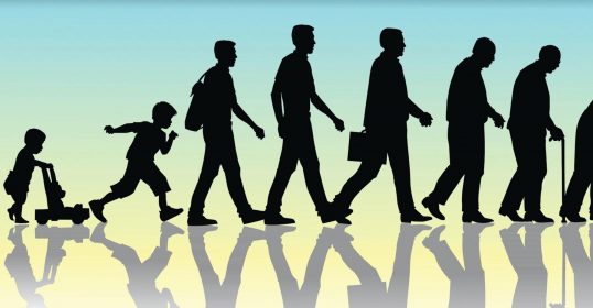 A silhouette of a group of people walking down the street.