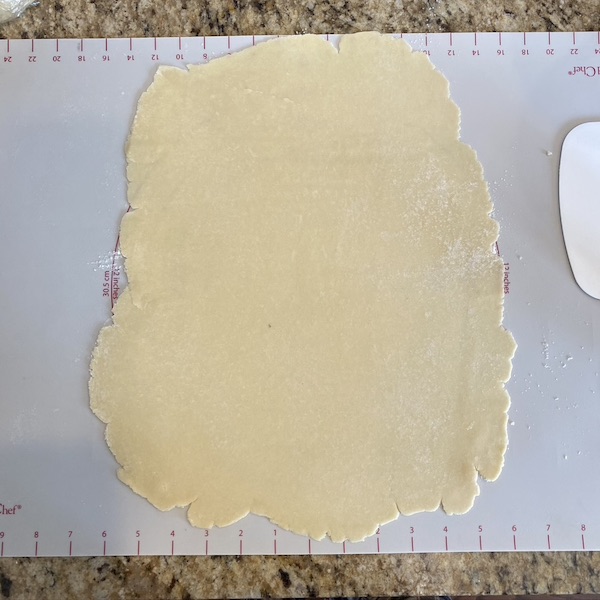 rolled out pie dough on a baking mat. 