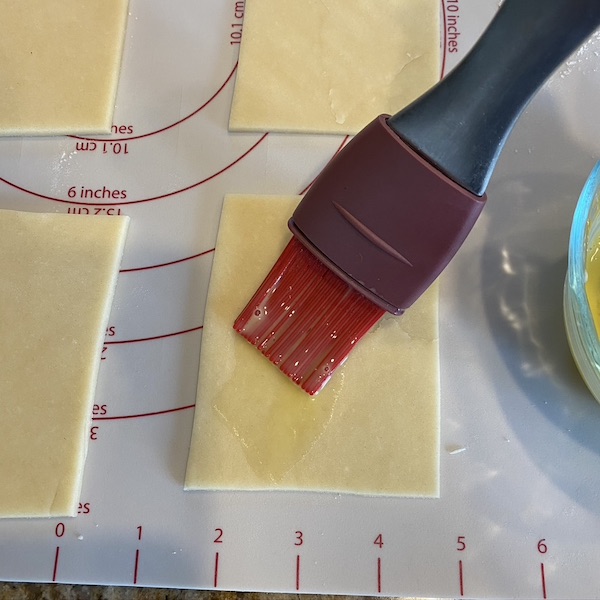 brushing egg wash on pop tart rectangles. 