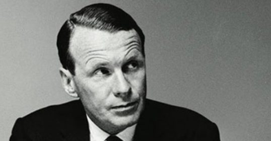 A black and white photo of an ad man in a suit.