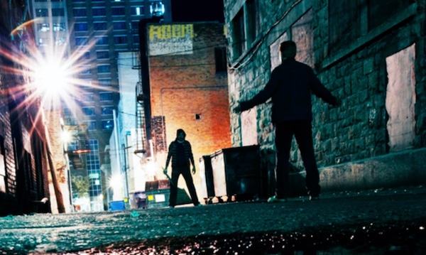 Two people standing in an alley at night, preparing themselves for any potential dangers.