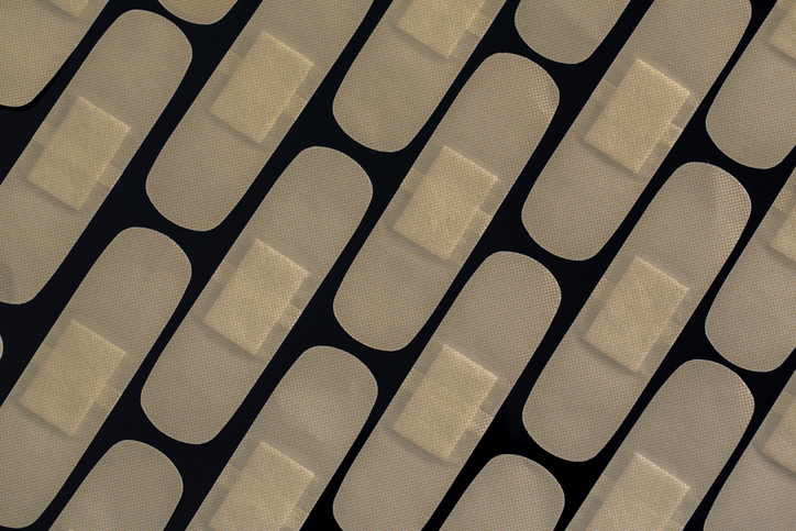 A close-up of a bandage on a black background.